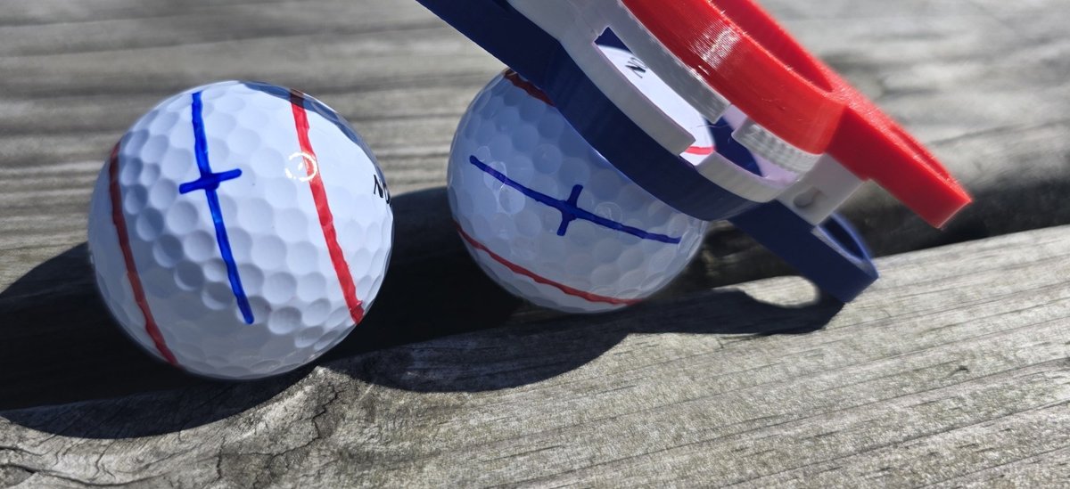 Golf balls marked with a center line and tick
