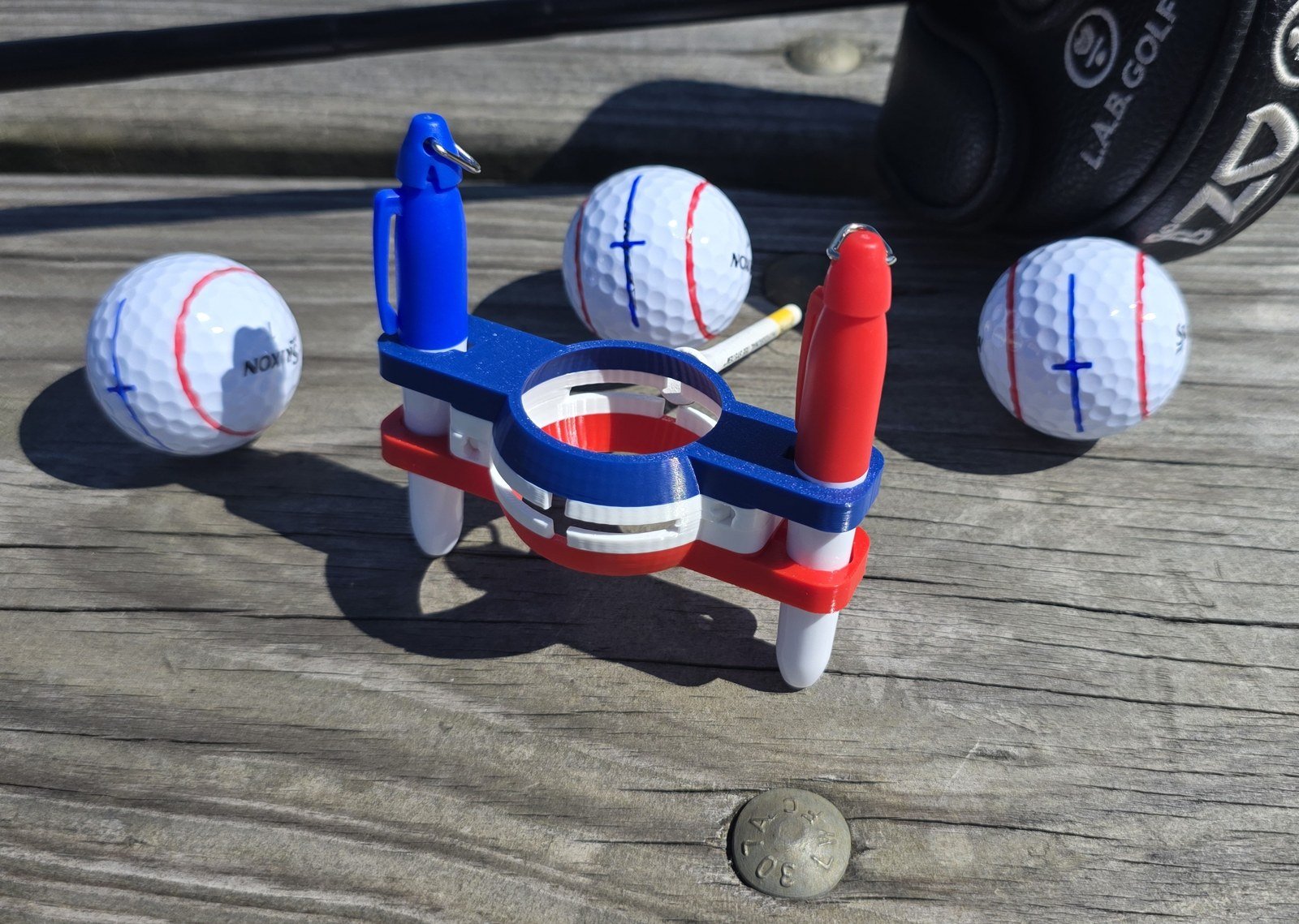The line marker holding a ball with two markers stored in the arms